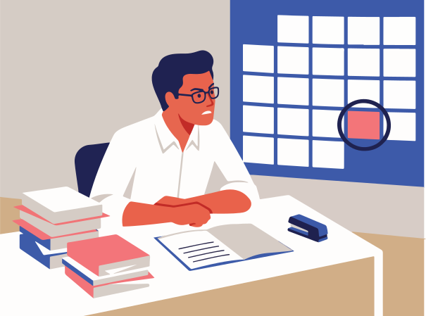 Man in glasses at desk with books and calendar.